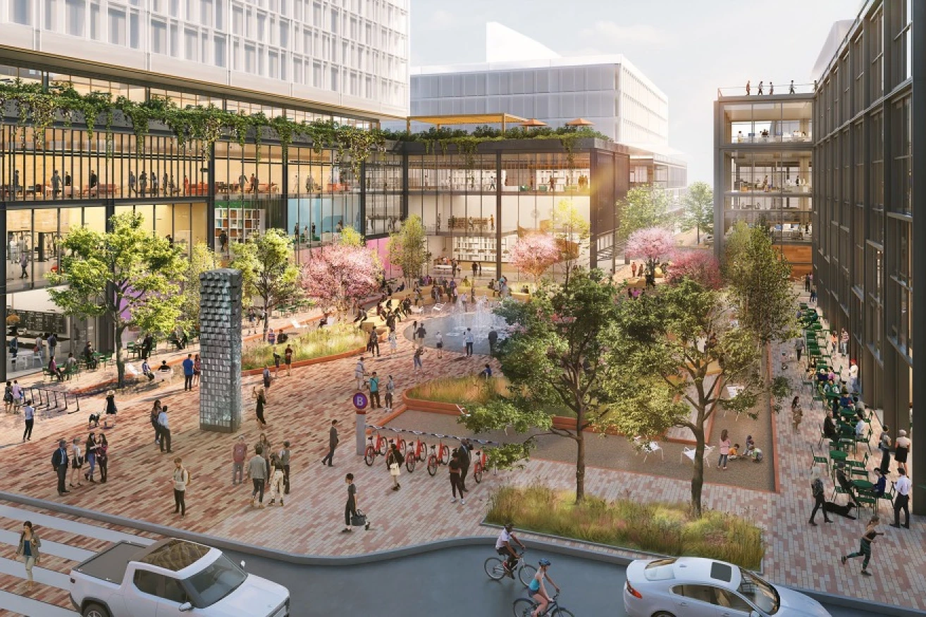 Central plaza with fountain, green landscaping, and people gathering for community events and programming