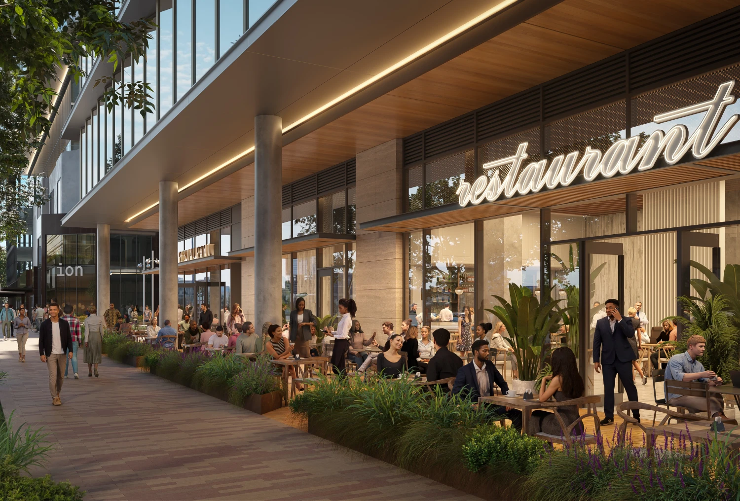 Evening diners enjoying food and conversation outside contemporary building with restaurant signage
